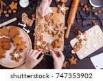 Cooking Christmas gingerbread. Friends decorating freshly baked cookies with icing and confectionery mastic, view from above. Festive food, family culinary, Christmas and New Year traditions concept