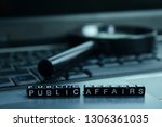 Public Affairs text wooden blocks in laptop background. Business and technology concept