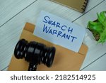Small photo of Search Warrant text on document above brown envelope with gavel.