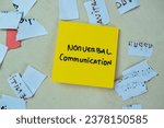 Concept of Nonverbal Communication write on sticky notes isolated on Wooden Table.
