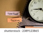 Small photo of Concept of TimeSheet Tracking write on sticky notes isolated on Wooden Table.