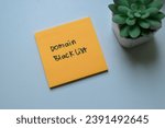 Small photo of Concept of Domain Blacklist write on sticky notes isolated on Wooden Table.