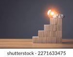 Finding the new inspiration concept, Light bulb put on top of wooden block stacked on wooden table. Use for the idea of future creative innovation, Learning, Education or working Concept, Studio shot.