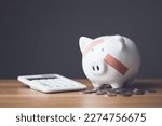Small photo of Financial problem, Bankrupt or fail in business concept. White piggy bank with plastic adhesive bandages on wooden desk with dark copy space wall background. Fail, Bankrupt or unsuccessful idea.