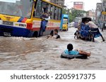 Small photo of Dhaka, Bangladesh - June 18, 2011: Vehicles try to drive through a flooded street in Dhaka, Bangladesh. Encroachment of canals is contributing to the continual water logging in Dhaka, Bangladesh.