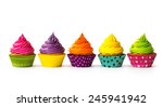 Colorful cupcakes on a white...
