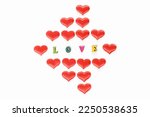 Inscription love made of wooden letters with hearts for Valentines Day. Festive hearts for declaration of love and strong relationship.