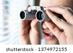 Small photo of Nosy neighbor or stalker with binoculars. Funny crazy man staring at people. Curious guy looking out the window. Silly face. Snooping and searching rumour or gossip. Peeping tom, pervert or voyeur.
