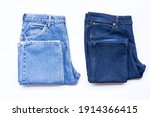 Blue jeans in a row, stack of denim pants, composition, denim texture.