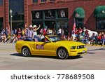 Small photo of Cody, Wyoming, USA - July 4th, 2009 - Then Wyoming secretary of state Max Maxfield with his wife Gayla Maxfield riding in a convertible and waving while participating in the Independence Day Parade