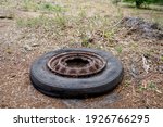 Old Tyre And Rim Dumped Outside