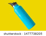 top view thermos water bottle. Blue water bottle wet isolated on yellow background