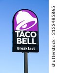 Small photo of Burlington, WA, USA - February 12, 2022; Taco Bell purple sign advertising breakfast on roadside signpost against a blue sky