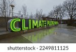 Small photo of Seattle, WA, USA - January 12, 2023; Illuminated green Climate Pledge Arena sign at the Seattle venue in the soaking rain