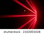 Small photo of Bright red neon laser lights illuminate the darkness creating lines and triangle shapes in sci-fi effect.