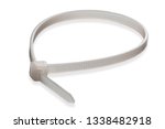 Small photo of close up detailed isolated macro shot of a single white plastic cable tie (also called: wire tie, zap strap, zip tie) on a white background