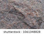 Small photo of Unwrought rough surface of pink granite stone