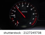Instrument panel with tachometer and fuel level temperature engine, Close up image of illuminated car dashboard. Red arrow 