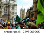 Small photo of Westminster, London, UK - April 22 2023: Extinction Rebellion climate protestors march through Westminster with banners on Earth Day.