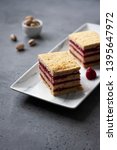 Small photo of Pistachio biscuit layered cake with fresh raspberry, square pieces, grey concrete background, nordic style