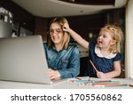 Small photo of Mother working from home with kid. Quarantine and closed nursery school during coronavirus outbreak. Child make noise and disturb woman at work. Homeschooling and freelance job. Stay at home.