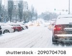 Scenic view traffic city jam at crossroad dirt snow covered slippery road drive slow moving cars stuck. Snowfall danger blizzard bad winter weather. Urban cold foggy day snowstrom town background