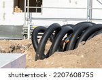 Black PVC flexible corrugated plastic insulation pipes tubing of electrical cables wire at undeground installation. New modern building construction site with engineering pipeline drainage technology