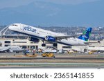 Small photo of Los Angeles, California, USA - February 23, 2018: JetBlue Airbus A321 is gaining altitude after take off from Los Angeles International Airport (LAX) in beautiful sunny day.