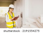 Small photo of Female architect recorded clipboard the amount lightweight brick stock used for wall construction and room interior construction to ensure accuracy and sufficient functionality.