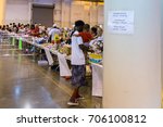 Small photo of Houston, Texas, August 30, 2017: Another shelter opens at NRG Center as refugees seek safety in Houston. A flood evacuee holding a small child receives necessary supplies