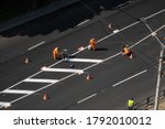 UKRAINE, KYIV - May 25, 2020: Road workers painting marking white line on the road surface. Thermoplastic spray marking machine during road construction.