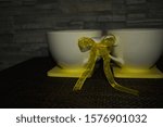 Small photo of Two white cups tied in place against the backdrop of decorative stone, with black tea, kava. Direct sunlight