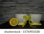 Small photo of Two white cups tied in place against the backdrop of decorative stone, with black tea, kava. Direct sunlight