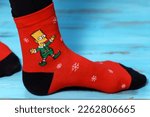 Small photo of Tyumen, Russia-January 23, 2023: Bart Simpson from The Simpsons animated series logo on clothes, Christmas socks