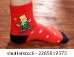 Small photo of Tyumen, Russia-January 23, 2023: Bart Simpson from The Simpsons animated series logo on clothes, Christmas socks