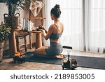 Small photo of Young Relaxed Woman Doing Yoga At Home With Candles And Incense.