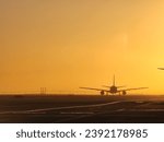 Aircraft taxiing during sunrise at San Francisco International Airport