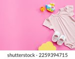Baby girl bodysuit with toys and accessories, flat lay.