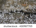 Castle on the stone path, a hail storm frozen ice background. Large ice balls after hail