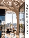 Small photo of Nantes, France - September 17, 2022: Travelers having a break in the concourse of Nantes SNCF train station, designed by Rudy Ricciotti, with the Castle of the Dukes of Brittany in the distance.