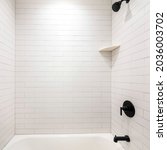 Small photo of Square frame Alcove bathtub with black plumbing fixtures and white subway tiles wall surround