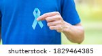 Small photo of November Prostate Cancer Awareness month, Man in blue T shirt with hand holding Blue Ribbon for supporting people living and illness. Healthcare, International men, Father and World cancer day concept
