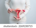 Woman holding uterus and...