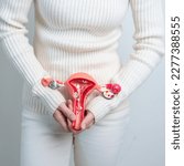 Small photo of Woman holding Uterus and Ovaries model. Ovarian and Cervical cancer, Cervix disorder, Endometriosis, Hysterectomy, Uterine fibroids, Reproductive system and Pregnancy concept