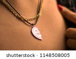 Women`s necklace in the shape of a broken heart.