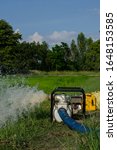 Small photo of Gasoline water pump recoil start and background is blue sky. Thai farmer are using to pump water for use in agriculture.
