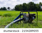 Small photo of Gasoline water pump recoil start and background is blue sky. Thai farmer are using to pump water for use in agriculture.
