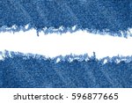 Destroyed torn denim blue jeans fabric frame on white background 