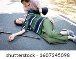 Small photo of Sick asian senior woman or mother is fainted and fallen on floor,daughter help,care,support of her,elderly people unconscious lying on the ground,concept of dizziness,fainting,losing consciousness