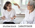 Small photo of Angry elderly people has quarrel violently with aggressive woman at home,annoyed senior mother pointing finger to daughter,arguing yell at each other,ungrateful,bad relations,family conflict concept